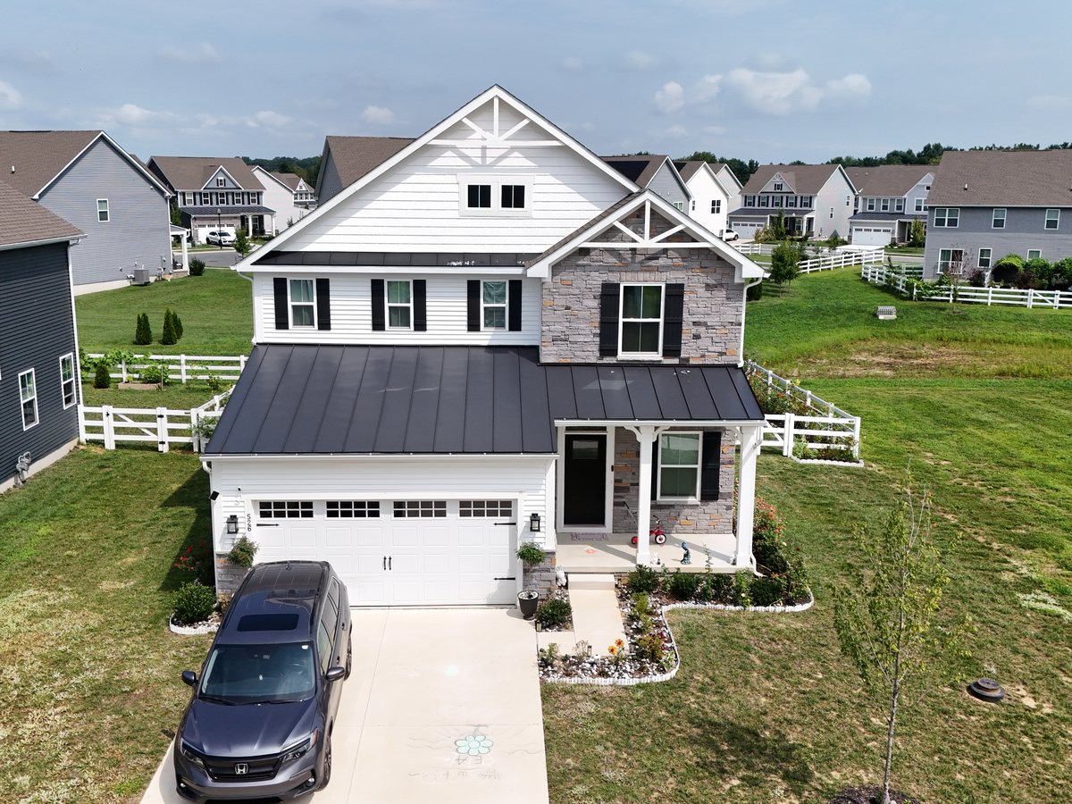 A closer aerial pass across the front of the same house and its neighbours
