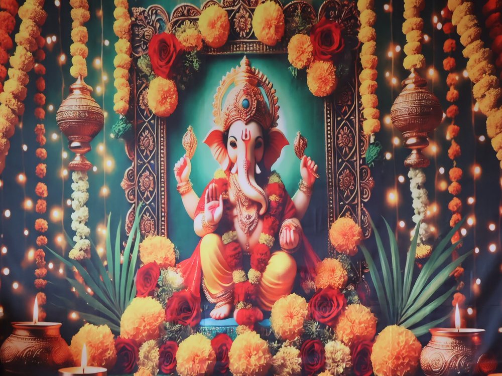 Ganesh Chaturthi backdrop framed with marigold garlands and brass pots