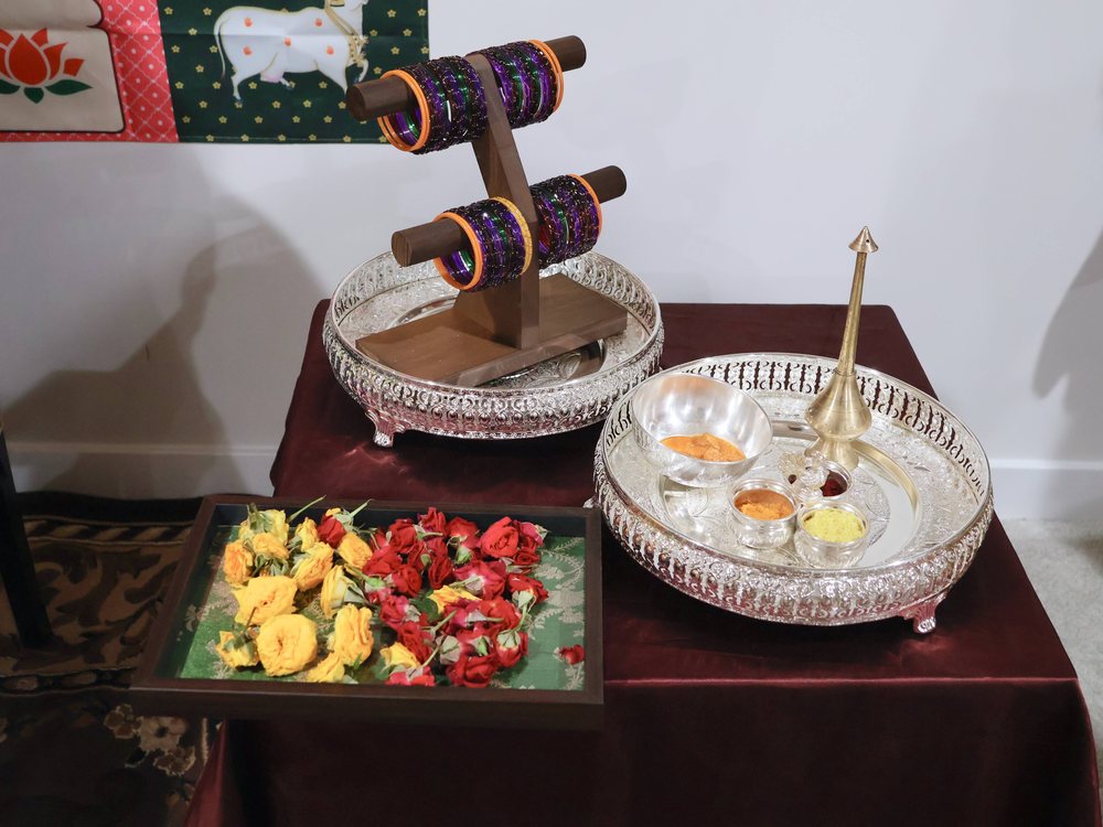 Seer varisai trays with rolled silks, silver plates and a fruit tray
